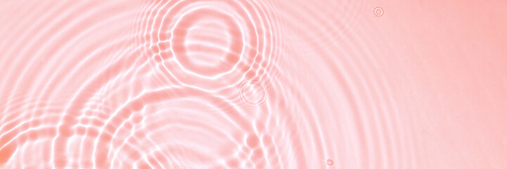 Pink water texture, cosmetic background pink water surface with rings and ripples. Spa concept...
