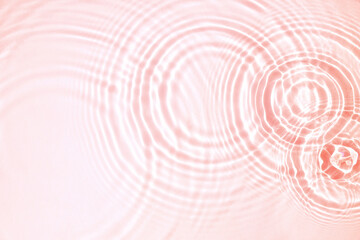 Pink water texture, cosmetic background pink water surface with rings and ripples. Spa concept background. Flat lay, copy space.