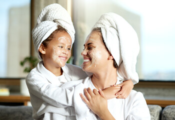 Happy, smiling and relaxed mother and daughter spa day at home with face masks for healthy skincare...