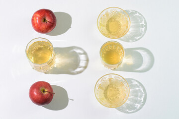 Apple cider vinegar and apples arranged on a table