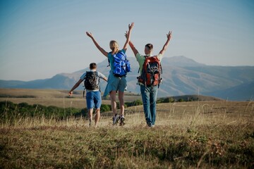 A group of tourists with backpacks are walking in mount