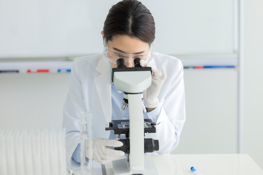 顕微鏡を覗く白衣の女性