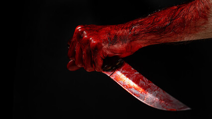 Man holding knife with bloody hand on black background.  - obrazy, fototapety, plakaty