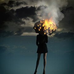 Girl with burning umbrella against the sky. Fiery rain