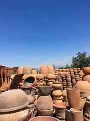 Stacks of various terracotta pots for plants for sale at a garden store.