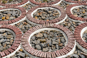 red brick pattern on stone background in park.