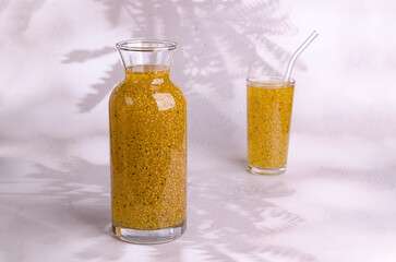 Yellow drink with seeds in a glass