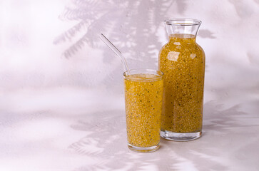 Yellow drink with seeds in a glass