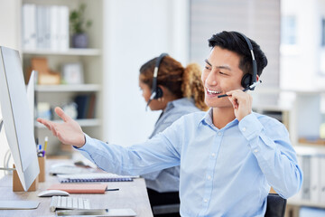 Happy, confident and helpful call centre agent talking on a headset while working on computer in an office. Salesman or consultant operating a help desk for customer care and service support