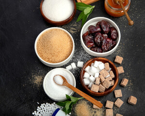 Various diet replacement for sugar on dark background.