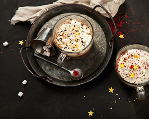 Cacao with marshmallow and cacao powder in mug.