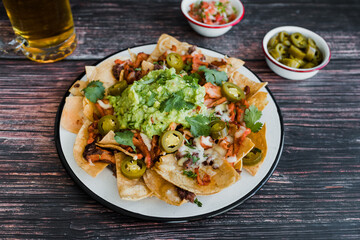 Mexican nachos chips with american cheese and avocado, traditional food in Mexico Latin America	