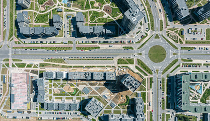 aerial top view of urban apartment houses and streets with roundabout intersection in a residential area - obrazy, fototapety, plakaty