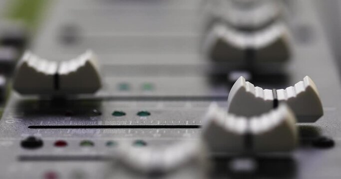 Racking Focus Shot Of Faders (Sliders) On Mixing Console. close up