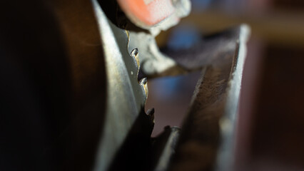Close-up of the teeth of a circular hand saw
