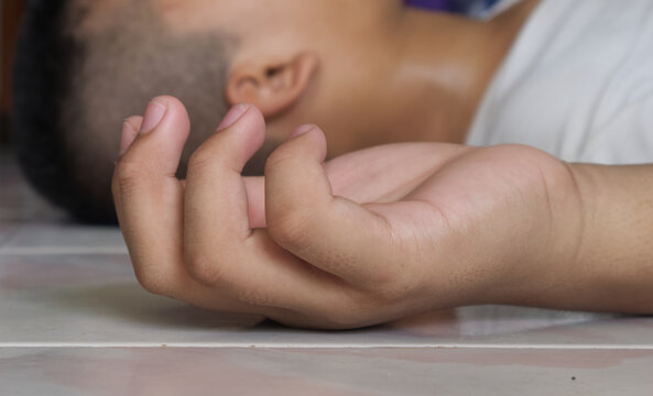 Close up hand of child unconscious in room