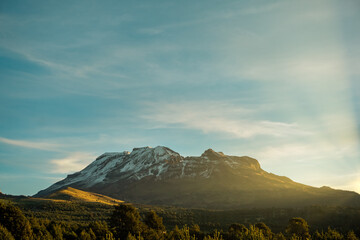 sunrise in front of the iztaccihuatl volcano