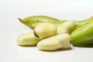 Fresh broad beans on a solid color background