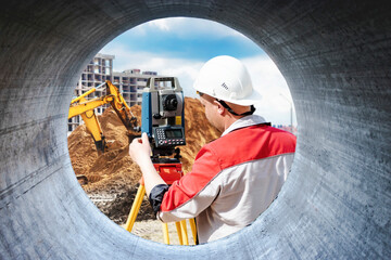 Surveyor engineer is measuring level on construction site. Surveyors ensure precise measurements...