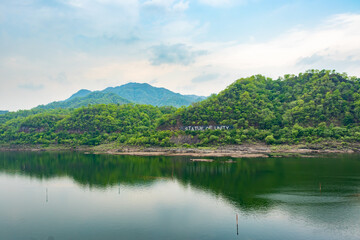 Naklejka na ściany i meble green mountain with river water reflection at morning from flat angle