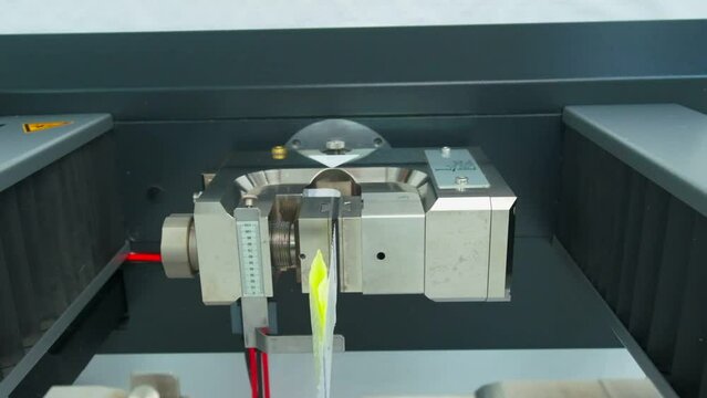 Polymer thread sample tape for plastic sack bags is tested for strength in laboratory