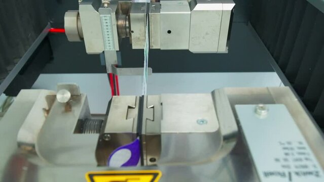 Polymer thread sample tape for plastic sack bags is tested for strength in laboratory
