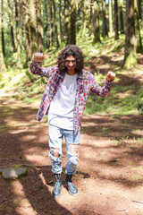 Fototapeta premium Young latin american man dancing in the forest at Costa Rica