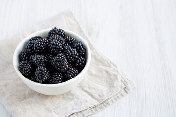Raw Blackberries in a Bowl, side view. Space for text.