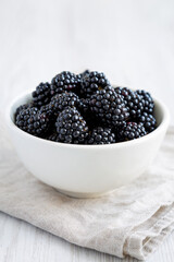 Raw Blackberries in a Bowl, side view. Close-up.