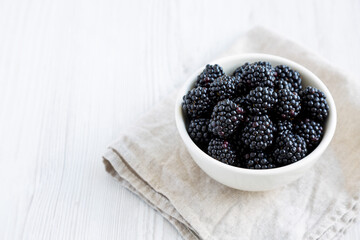 Raw Blackberries in a Bowl, side view. Copy space.