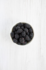 Raw Blackberries in a Bowl, top view. Flat lay, overhead, from above.