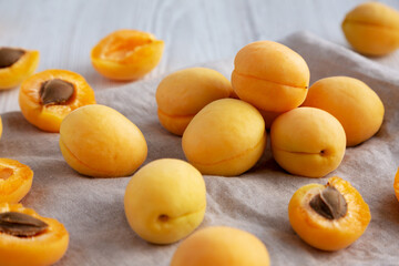 Raw White Apricot Angelcots on a white wooden background, low angle view. Close-up.