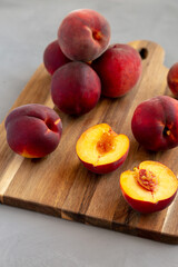 Fototapeta na wymiar Raw Organic Yellow Peaches on a wooden board, side view.