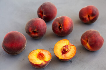 Fototapeta na wymiar Raw Organic Yellow Peaches on a gray background, side view.