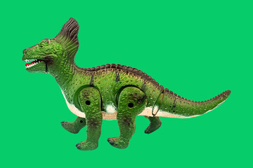 Dinosaur toy on green screen background. Take a photo and cut the background and overlay with green...