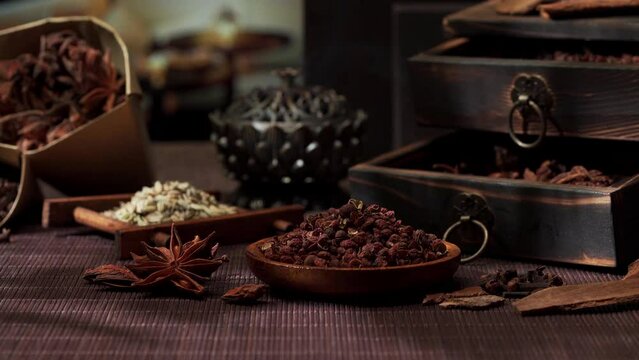 Chinese traditional seasoning five spice powder and raw materials on retro background