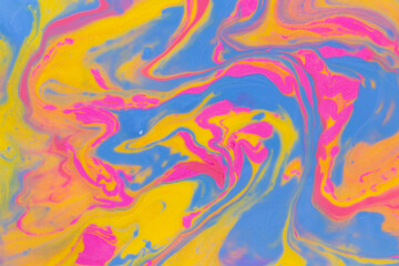 Fototapeta na wymiar Abstract background of mixed shades of nail polish with a shiny marble pattern. Liquid colorful paint background creative yellow and pink with shimmer and blue