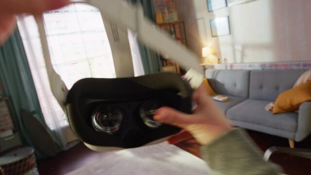 Immersive Point of View Shot of Person Putting On Virtual Reality Headset to Play VR Video Game at Home. Using VR Glasses to Have Fun in Metaverse. Cool Authentic First Person Handheld Shot.