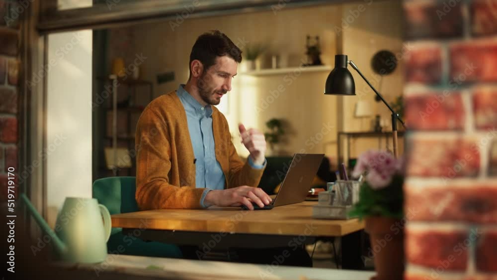 Poster handsome man typing on laptop computer in stylish loft apartment during sunny day. creative male che
