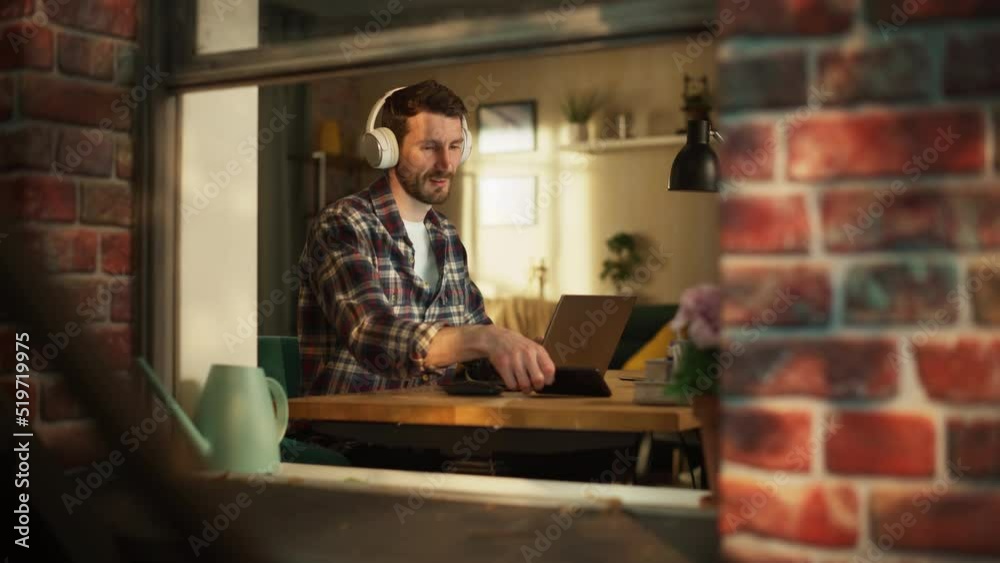 Aufkleber handsome caucasian man working on laptop computer while sitting behind his desk at home office. free