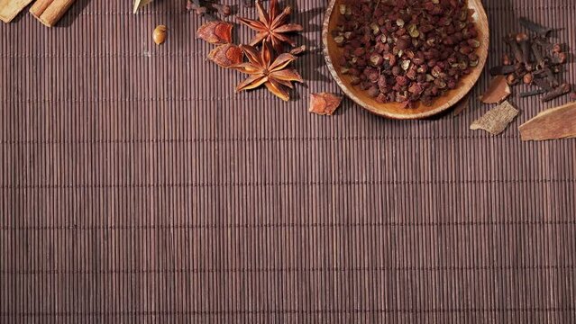 Chinese traditional seasoning five spice powder and raw materials on retro background
