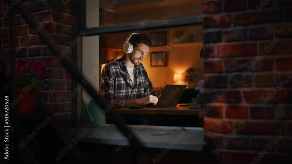 Poster creative professional man opens laptop, puts on headphones and starts working. it specialist writes 