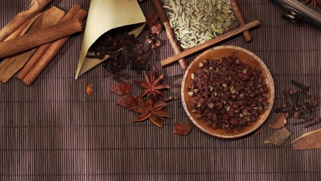 Chinese traditional seasoning five spice powder and raw materials on retro background