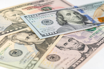 5, 20, 50, 100 dollars banknotes at different angles. Close up of dollars on white background.
