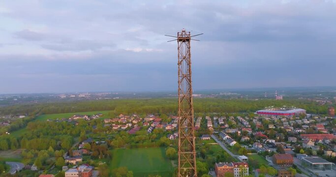 Aerial view of the wooden broadcasting tower in Gliwice with the city of Gliwice in the background. The concept of the largest wooden tower in the world. Wooden construction from a drone.