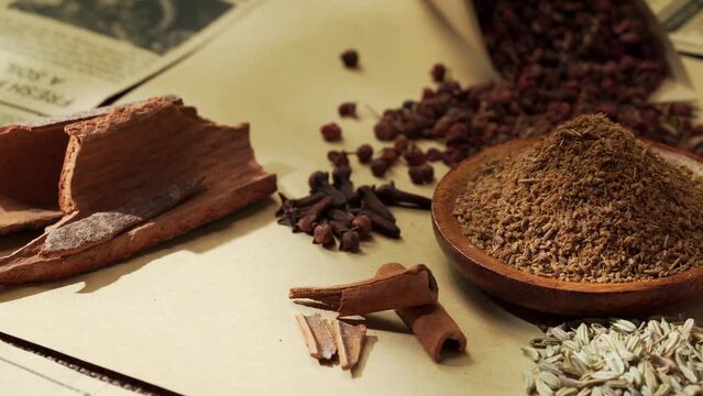 Chinese traditional seasoning five spice powder and raw materials on retro background