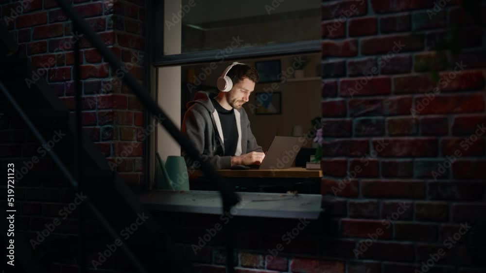 Poster software developer programming on a laptop late night. male specialist browsing internet, listening 