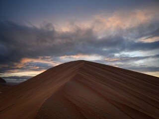 Fototapeta na wymiar Dramatic clouds over the sand dunes