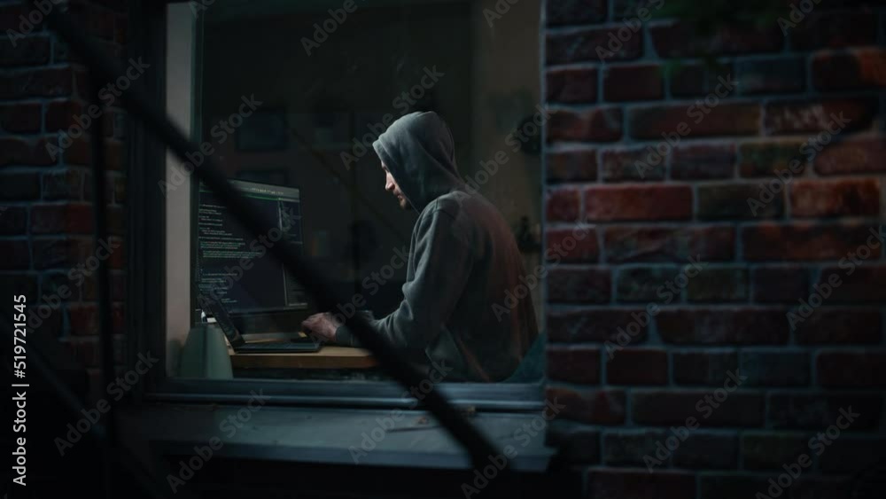 Poster night apartment: evil male hacker wearing hoodie breaks into data server room, ddos attack, phishing