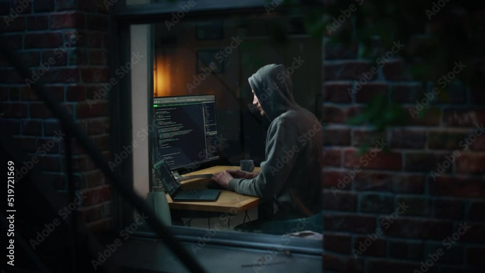 Poster night apartment: evil male hacker wearing hoodie breaks into data server room, ddos attack, phishing